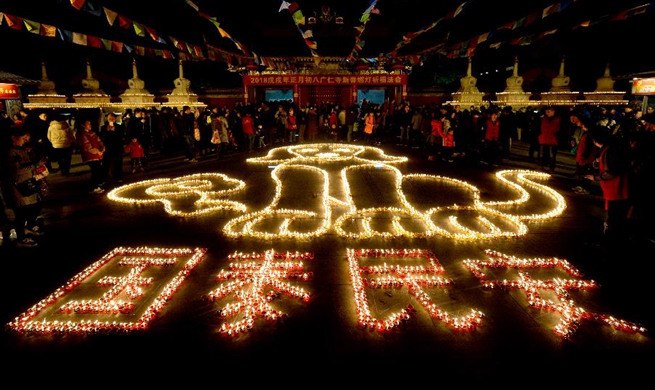 Citizens, tourists light butter lamps in NW China to express good wishes